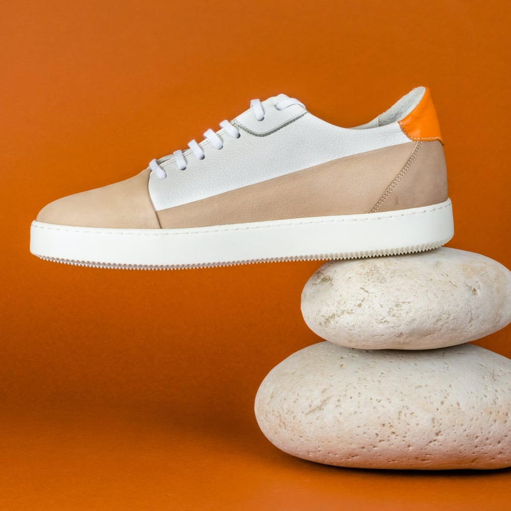 a sneaker in balance on two rocks superposed